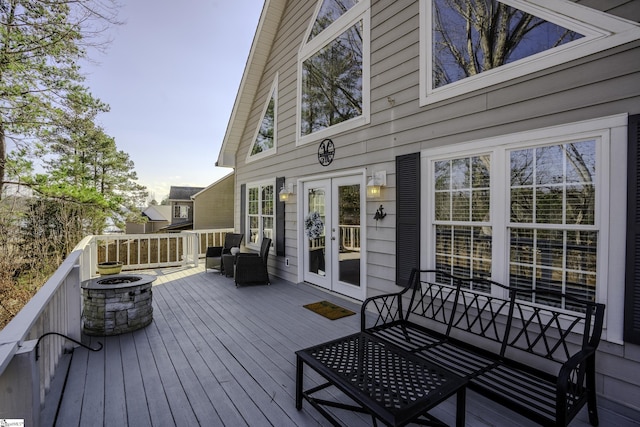 deck featuring french doors and an outdoor living space with a fire pit