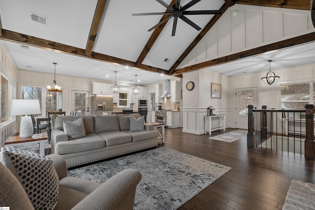 living room featuring ceiling fan with notable chandelier, high vaulted ceiling, dark hardwood / wood-style floors, and beamed ceiling