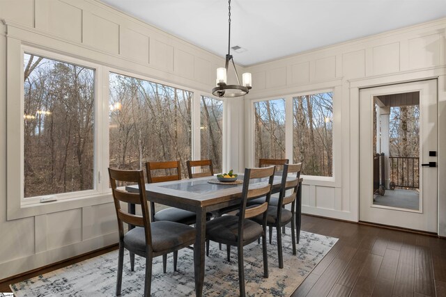 dining space with dark hardwood / wood-style flooring