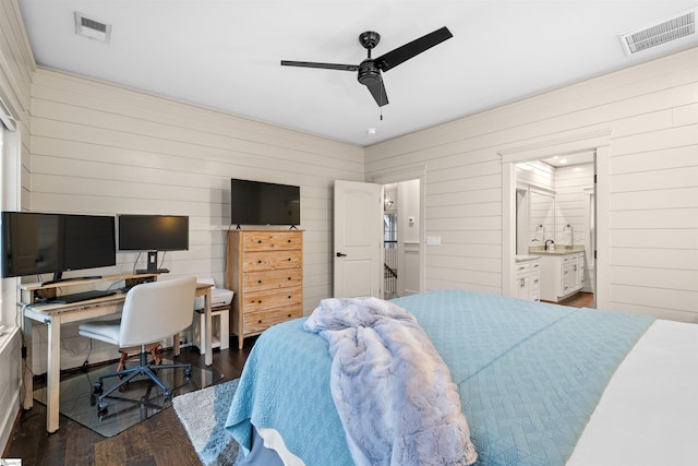 bedroom featuring ceiling fan, ensuite bathroom, and dark hardwood / wood-style floors