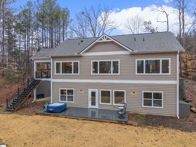 rear view of property featuring a wooden deck