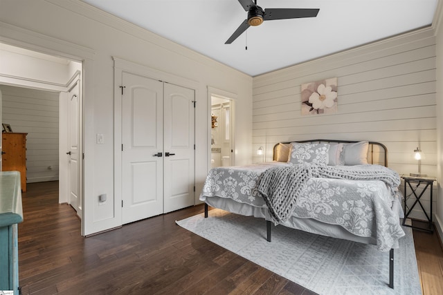 bedroom with ceiling fan, dark hardwood / wood-style flooring, ensuite bath, and a closet