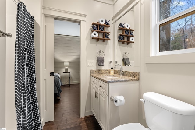 bathroom with vanity, hardwood / wood-style flooring, and toilet