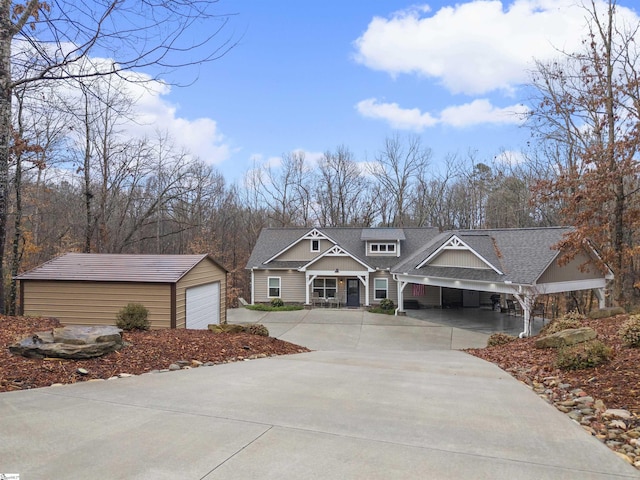 view of front of home with a garage, an outdoor structure, and a carport