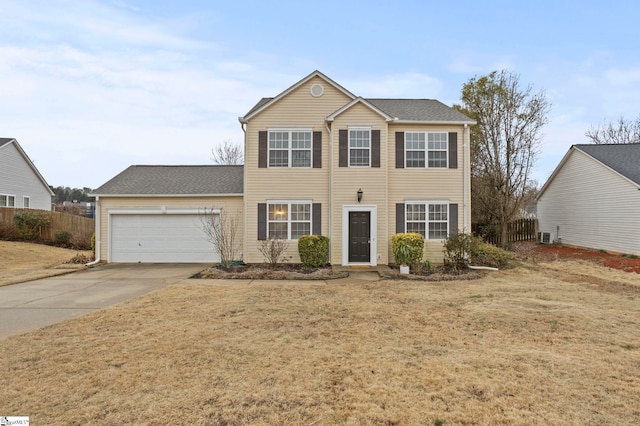 colonial home featuring a garage and a front lawn