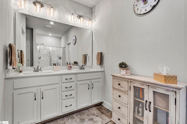 bathroom with walk in shower and vanity