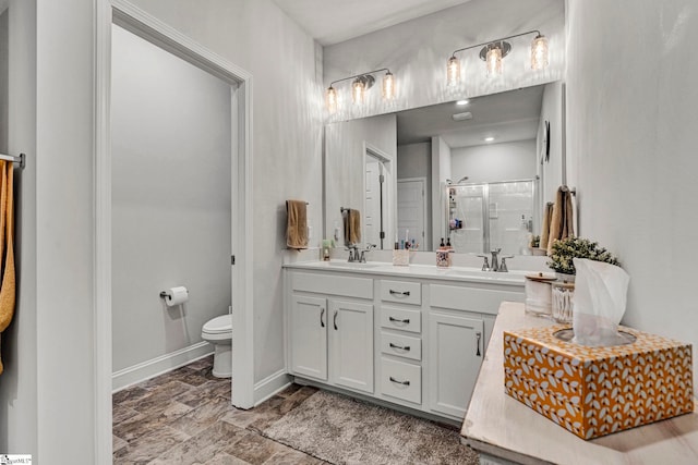 bathroom featuring vanity, toilet, and walk in shower