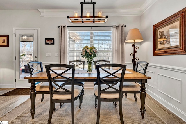 dining space featuring ornamental molding and hardwood / wood-style floors