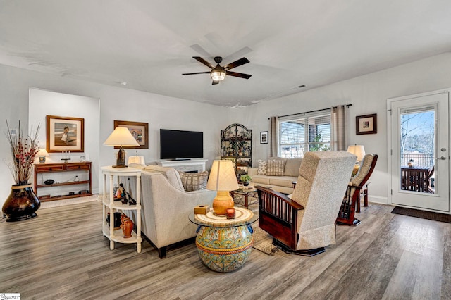 living room with hardwood / wood-style flooring and ceiling fan