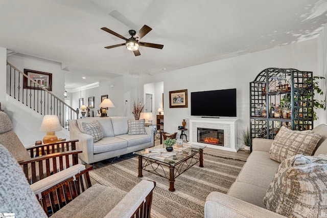 living room with wood-type flooring and ceiling fan