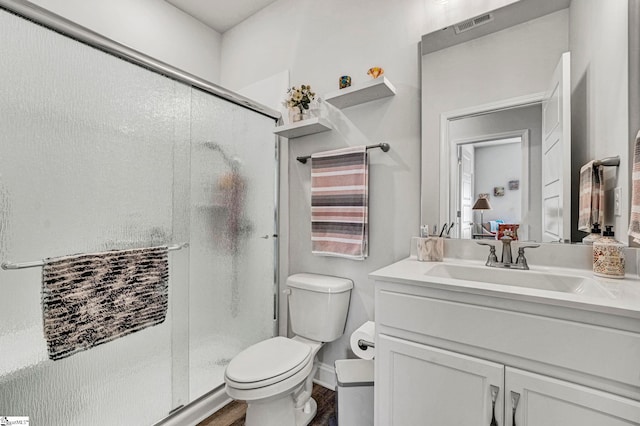 bathroom with walk in shower, vanity, toilet, and hardwood / wood-style floors