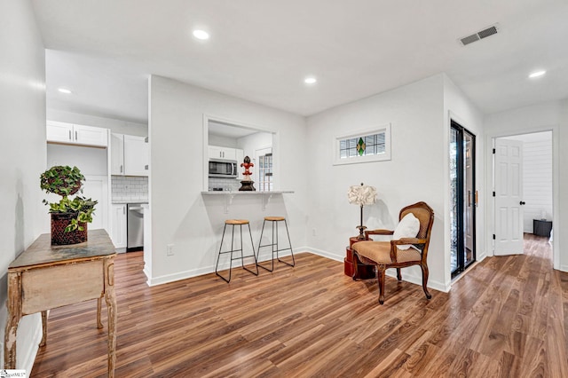 living area with hardwood / wood-style floors