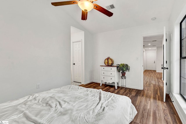 bedroom featuring dark hardwood / wood-style flooring, lofted ceiling, and ceiling fan