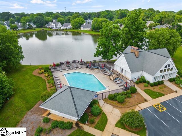 view of swimming pool featuring a water view and a patio