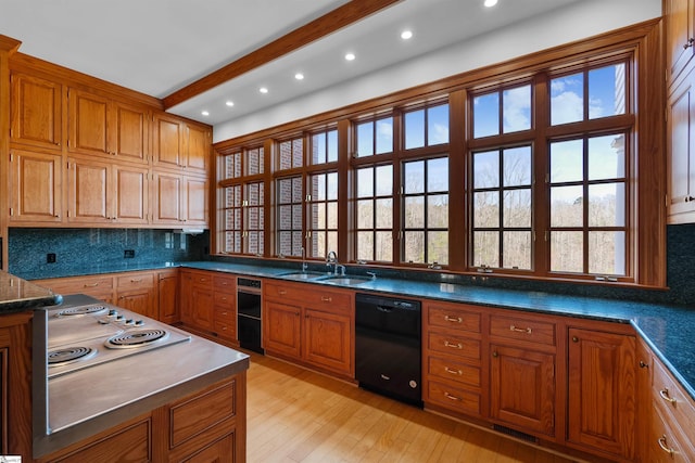 kitchen featuring dishwasher, sink, backsplash, beam ceiling, and light hardwood / wood-style flooring