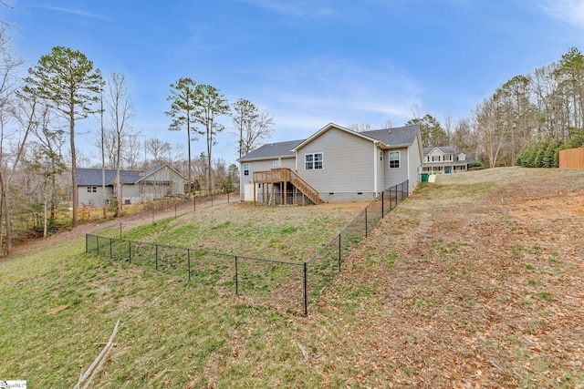 exterior space with a wooden deck and a lawn