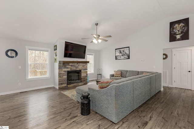 living room with ceiling fan, a fireplace, dark hardwood / wood-style flooring, and vaulted ceiling