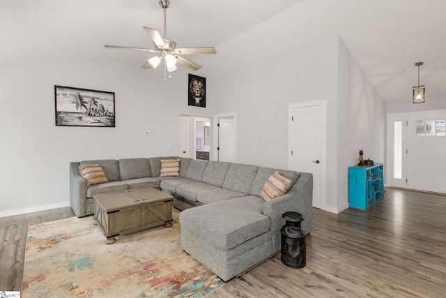 living room with ceiling fan, wood-type flooring, and high vaulted ceiling