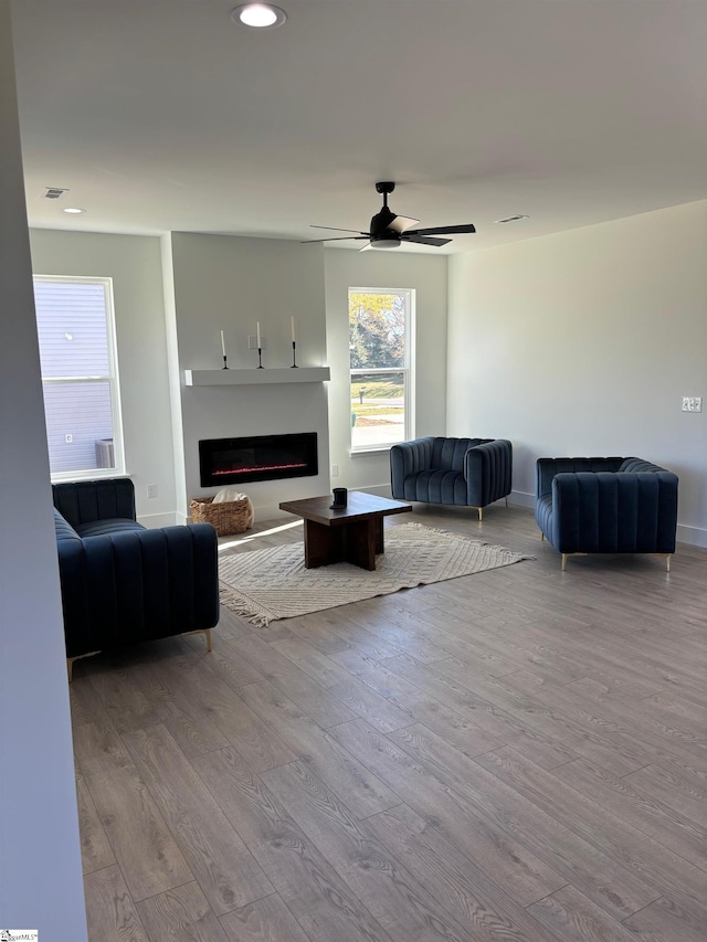 living room with ceiling fan and light hardwood / wood-style floors