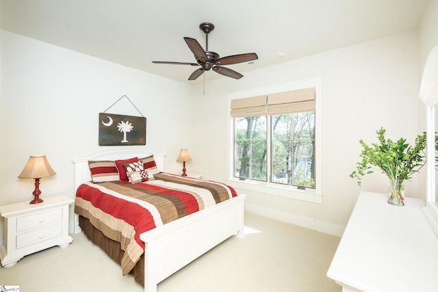 bedroom with light carpet and ceiling fan
