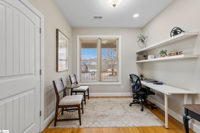 office with light hardwood / wood-style floors