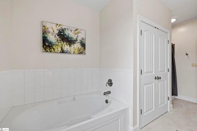 bathroom with tile patterned flooring and a tub