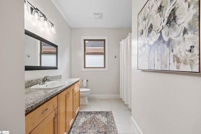 bathroom featuring tile patterned floors, vanity, and toilet