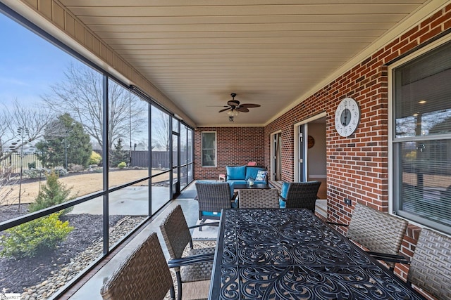 sunroom / solarium featuring ceiling fan