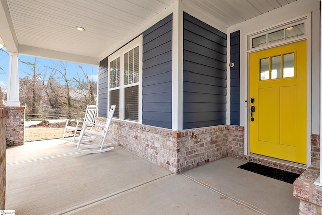 view of exterior entry with a porch