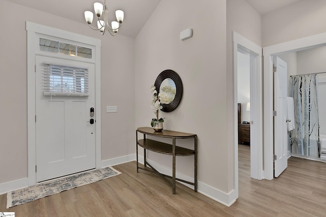 foyer with a chandelier and light hardwood / wood-style flooring