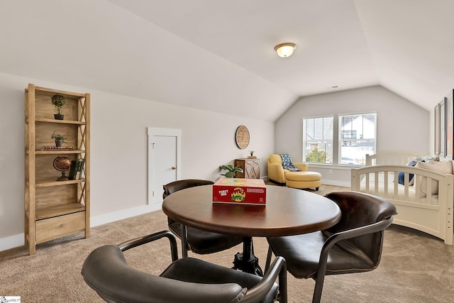 dining room featuring light colored carpet and lofted ceiling