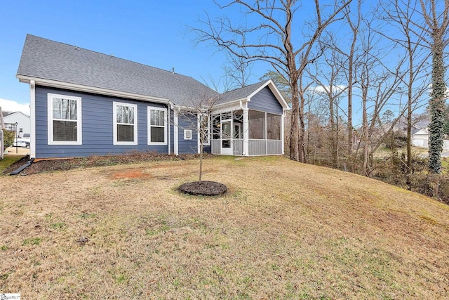 view of front of house with a sunroom and a front yard