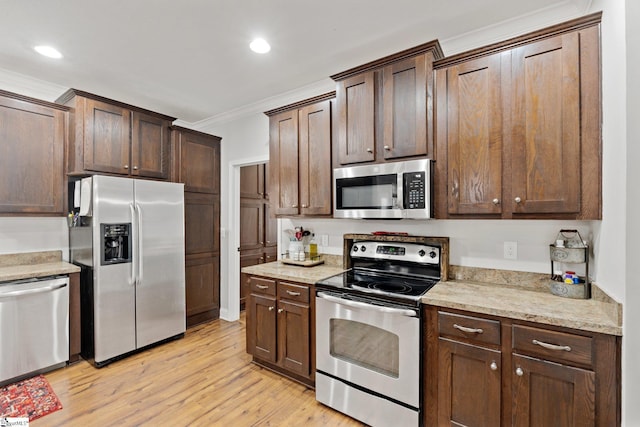 kitchen featuring appliances with stainless steel finishes, dark brown cabinetry, light hardwood / wood-style floors, crown molding, and light stone countertops