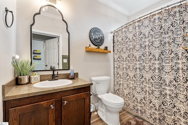 bathroom with crown molding, vanity, toilet, and hardwood / wood-style floors