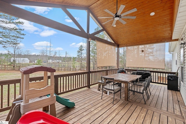 wooden deck featuring grilling area and ceiling fan