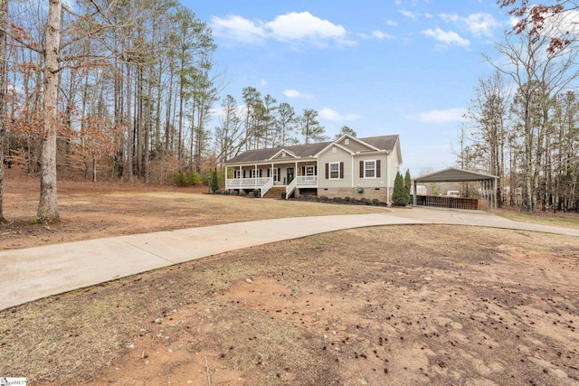 view of front of property with a carport and covered porch