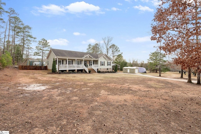 view of front of property with a storage unit and covered porch