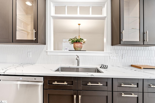 kitchen with sink, decorative backsplash, stainless steel dishwasher, crown molding, and light stone countertops