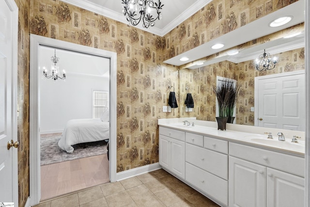 bathroom featuring tile patterned flooring, ornamental molding, a notable chandelier, and vanity