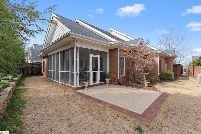 back of property featuring a patio and a sunroom