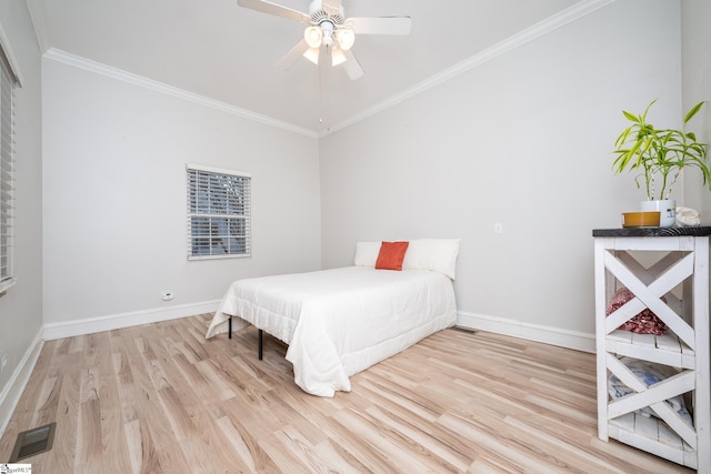 bedroom featuring ceiling fan, ornamental molding, and light hardwood / wood-style floors