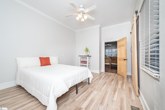 bedroom featuring crown molding, ceiling fan, a barn door, and light wood-type flooring