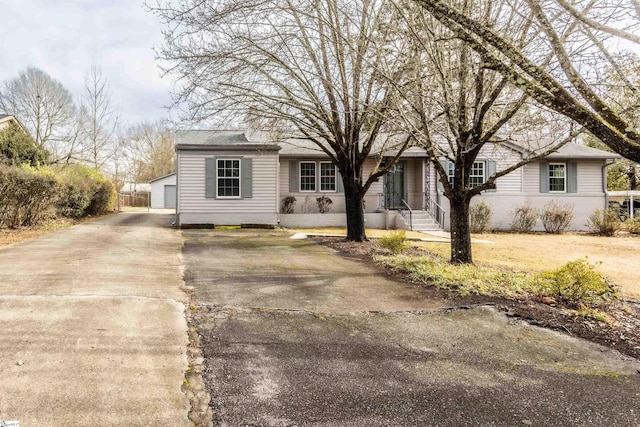 view of front of property featuring a garage and an outbuilding