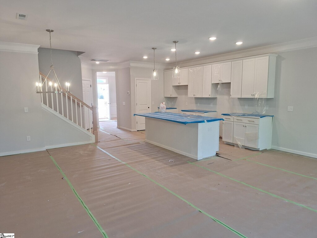kitchen with white cabinets, baseboards, ornamental molding, and recessed lighting