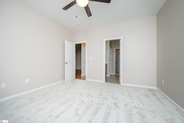 unfurnished bedroom featuring light colored carpet and ceiling fan