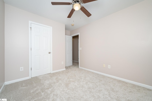 unfurnished bedroom with ceiling fan and light carpet