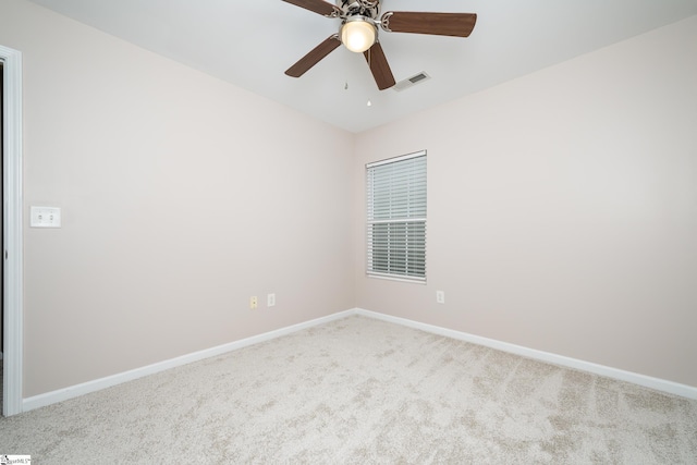 carpeted empty room featuring ceiling fan