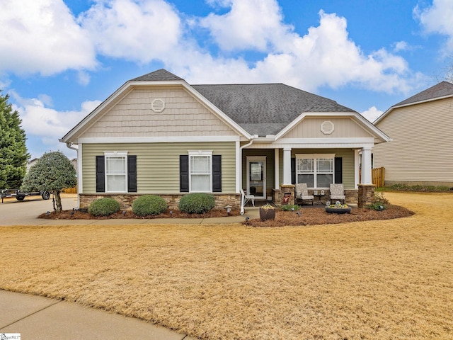 craftsman-style house featuring a porch and a front yard