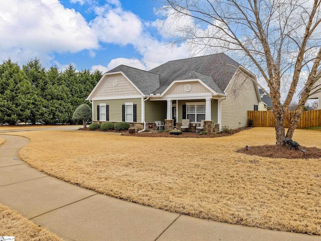 craftsman inspired home featuring a front lawn and a porch