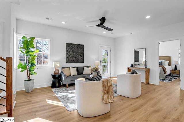 living room featuring ceiling fan and light hardwood / wood-style flooring